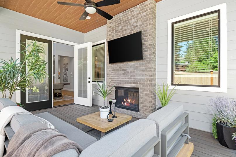 Outside is an incredible covered living area with a fireplace.