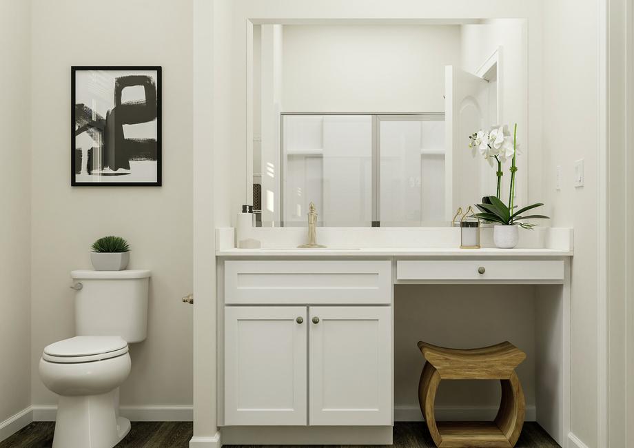 Rendering of the spacious master bath in  the Allatoona. The view is facing the white-cabinet vanity with makeup area.  The toilet is beside it and the shower is reflected in the mirror.