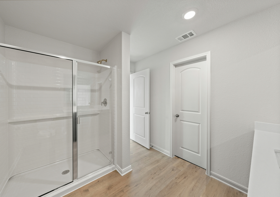 The master bathroom has a large walk-in, glass shower.