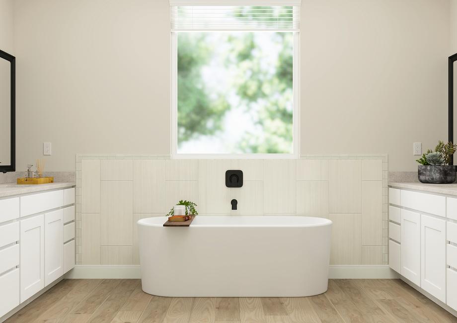 Rendering of the incredible master bath
  in the Orchid floor plan. A soaking tub is positioned between two vanities
  with white cabinets and black fixtures. A large window provides natural
  light.