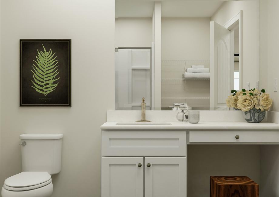 Rendering of the spacious master bath  focused on the sink, which has white cabinets and a makeup vanity. The toilet  is beside it and in the mirror's reflection the shower and linen storage is  visible.