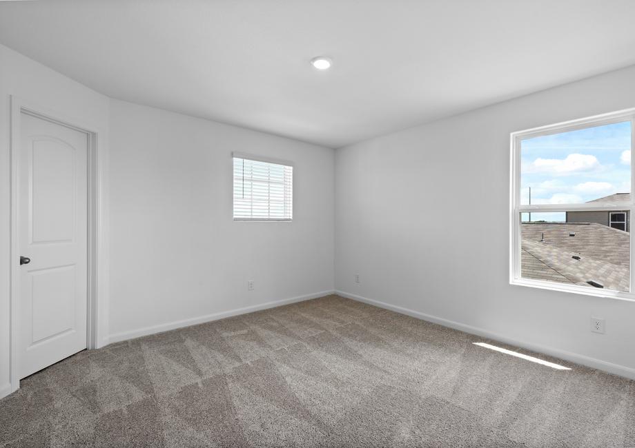 A spacious bedroom with a walk-in closet