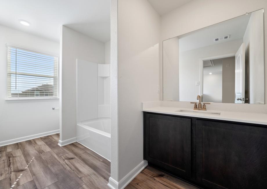 The secondary bathroom in the Cypress has a shower-tub combo.