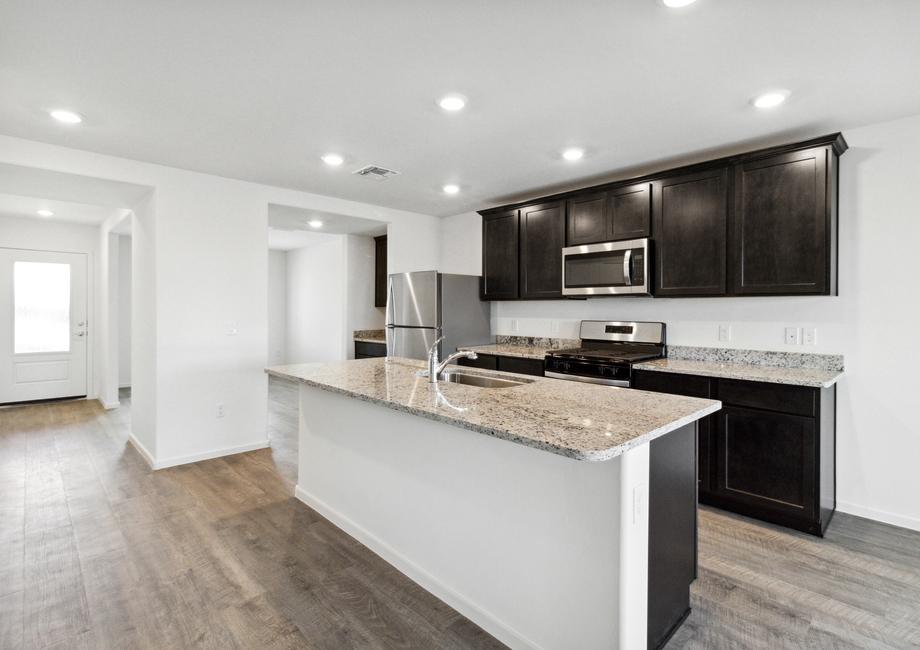 The kitchen boasts stainless steel appliances, granite countertops, and espresso cabinetry.
