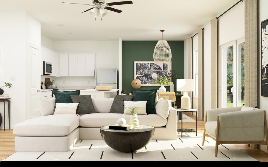 Rendering of living room with a large
  sectional couch. The kitchen can be seen from behind the couch.
