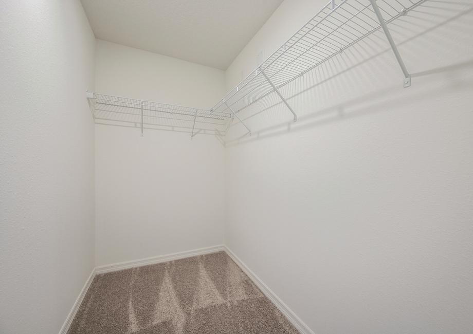 The walk in closet is spacious and ready for your wardrobe