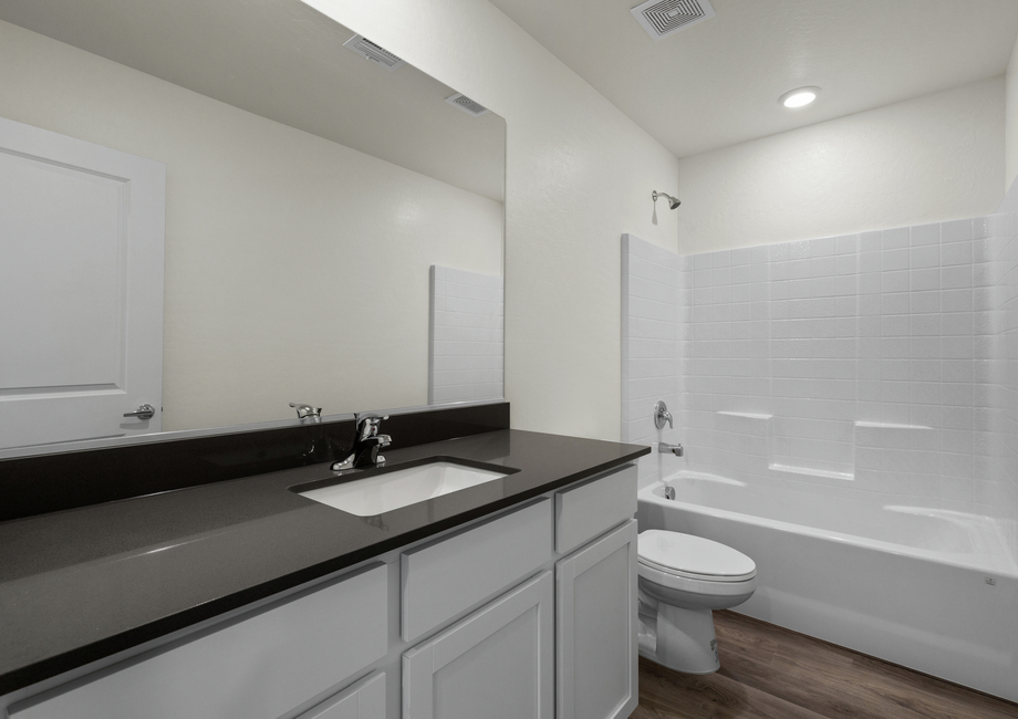 The secondary bathroom of the Oak has a large vanity space and shower-tub combo.