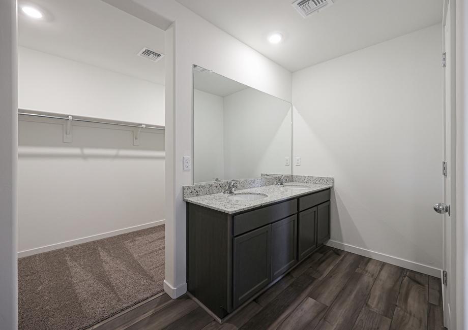 This master bath has a stunning vanity with two sinks and granite countertops.