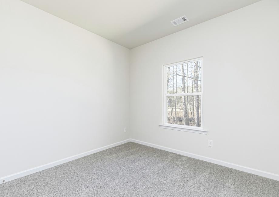 Secondary bedrooms in the Cypress include tan carpets, closets and bright windows