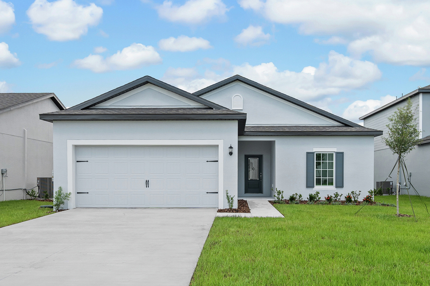 Exterior photo of the Boca plan with a two-car garage and professional landscaping