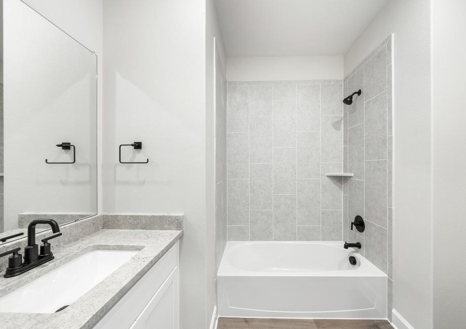 The secondary bathroom of the Blanco has a large vanity space and a shower-tub combo.