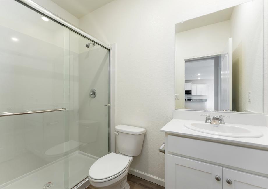 The secondary bathroom has a step in shower.