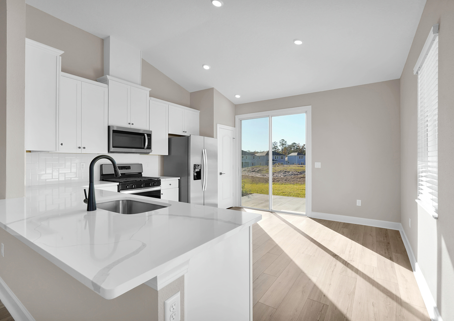 Enjoy breakfast in this kitchen and dining area