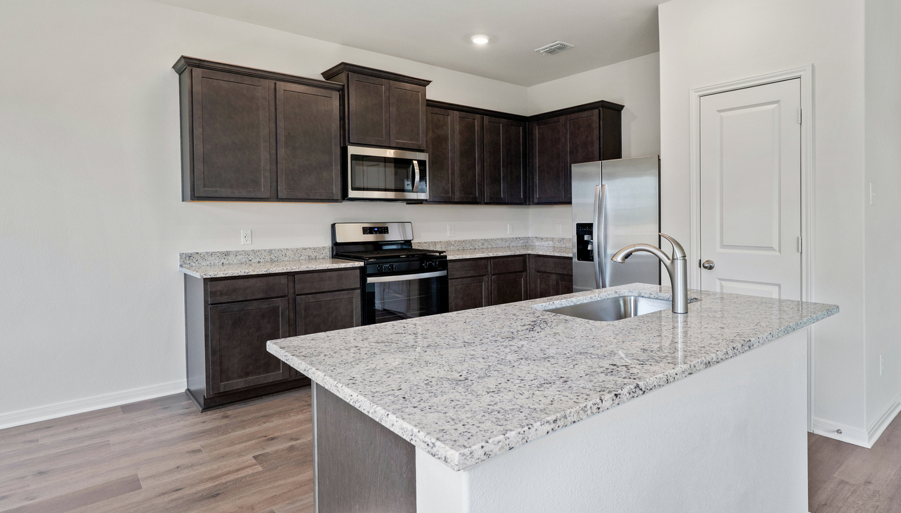 The kitchen has beautiful wood cabinetry.