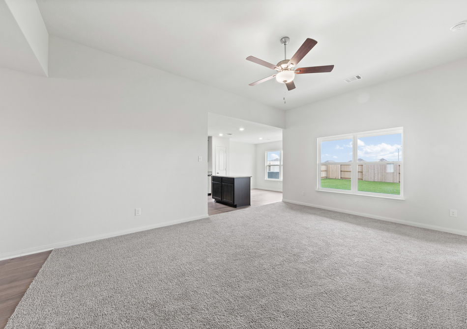 The family room of the Blanco has a large window that lets in great natural light.