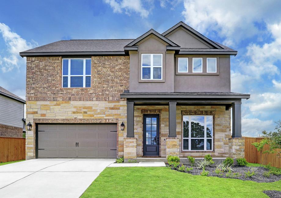 Exterior of the Brazos with stone and brick, a covered front porch, and professional landscaping.