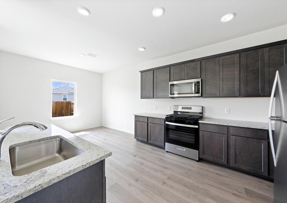 The kitchen has gorgeous wood cabinetry.