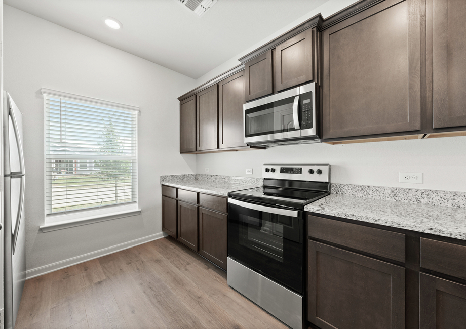 The kitchen of the Driftwood has beautiful wood cabinetry.