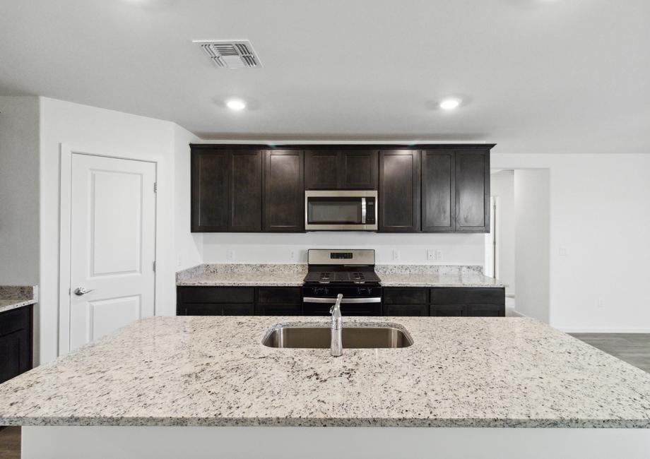 Upgraded kitchen with a large island and stainless steel appliances.