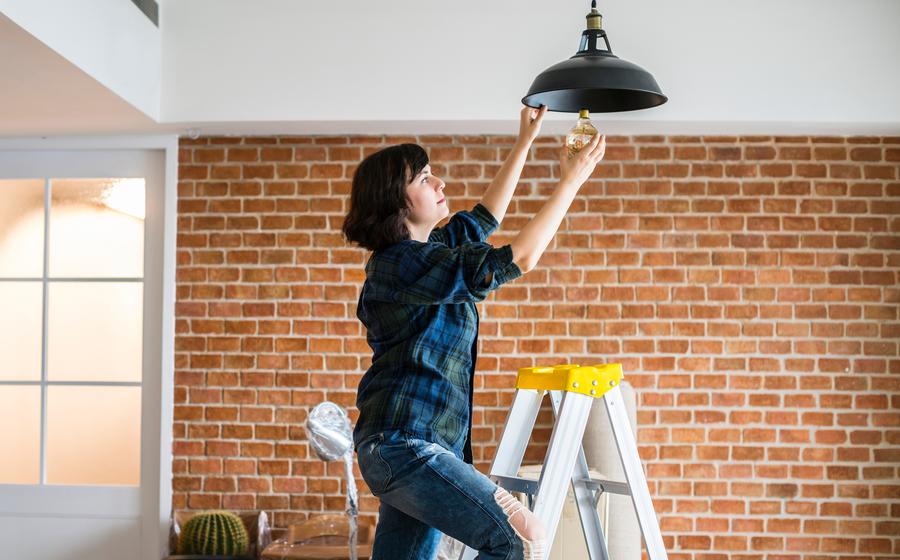 Woman changing a lightbulb