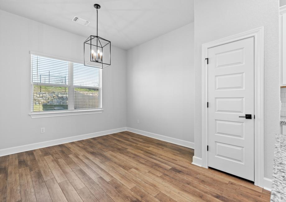 <p>Dining room situated directly off of the kitchen including fashion lighting fixture.</p>