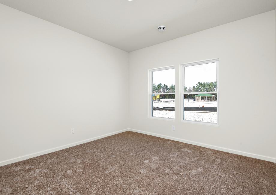 The master bedroom is spacious and a large window.