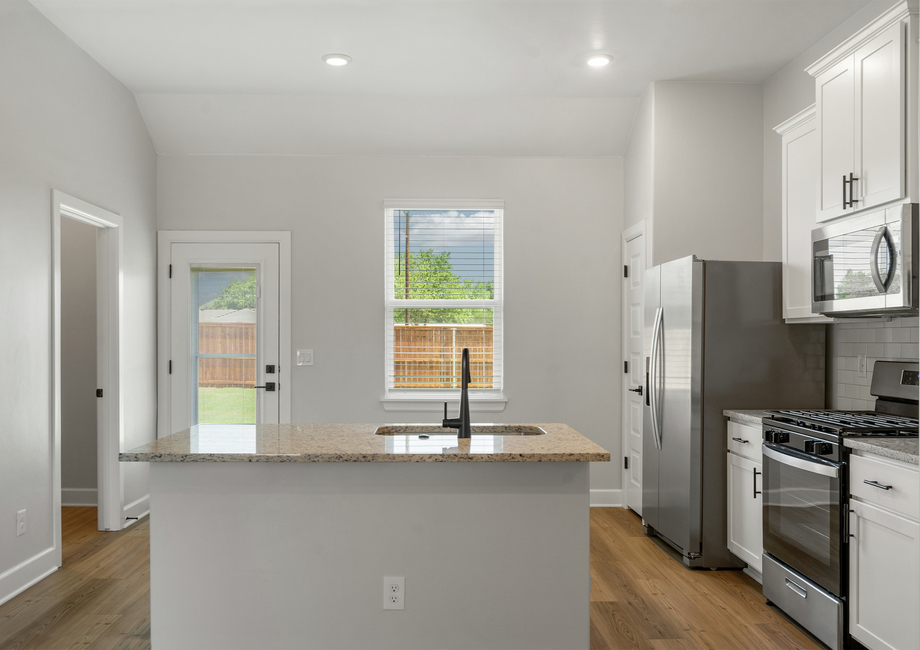 The upgraded kitchen has a convenient kitchen island for added convenience.