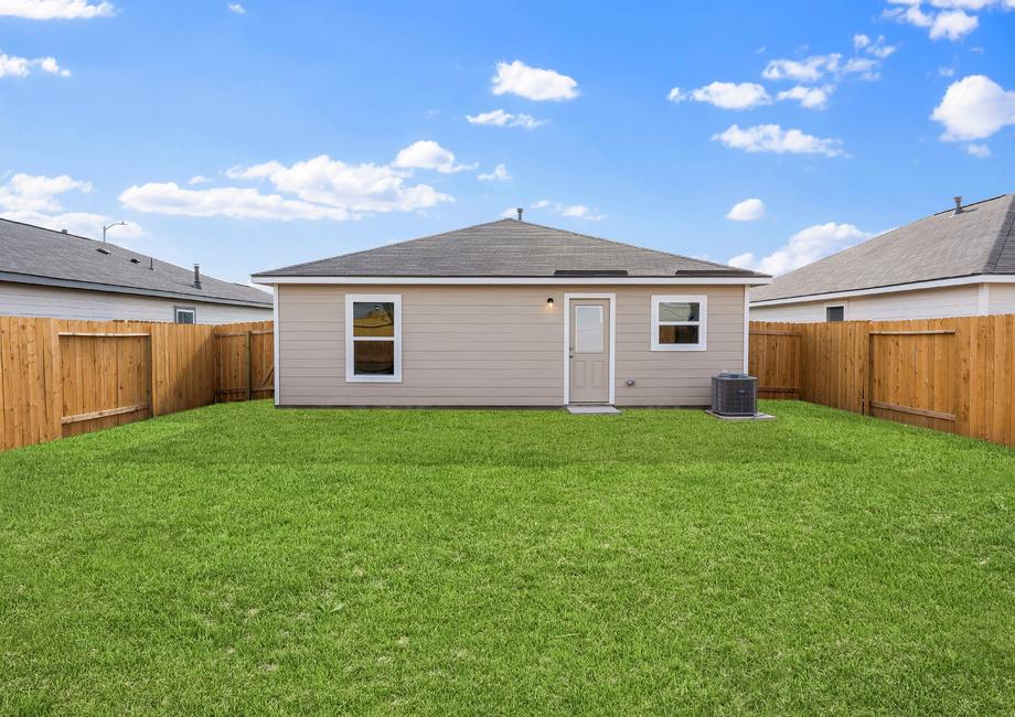 A spacious backyard with grass.