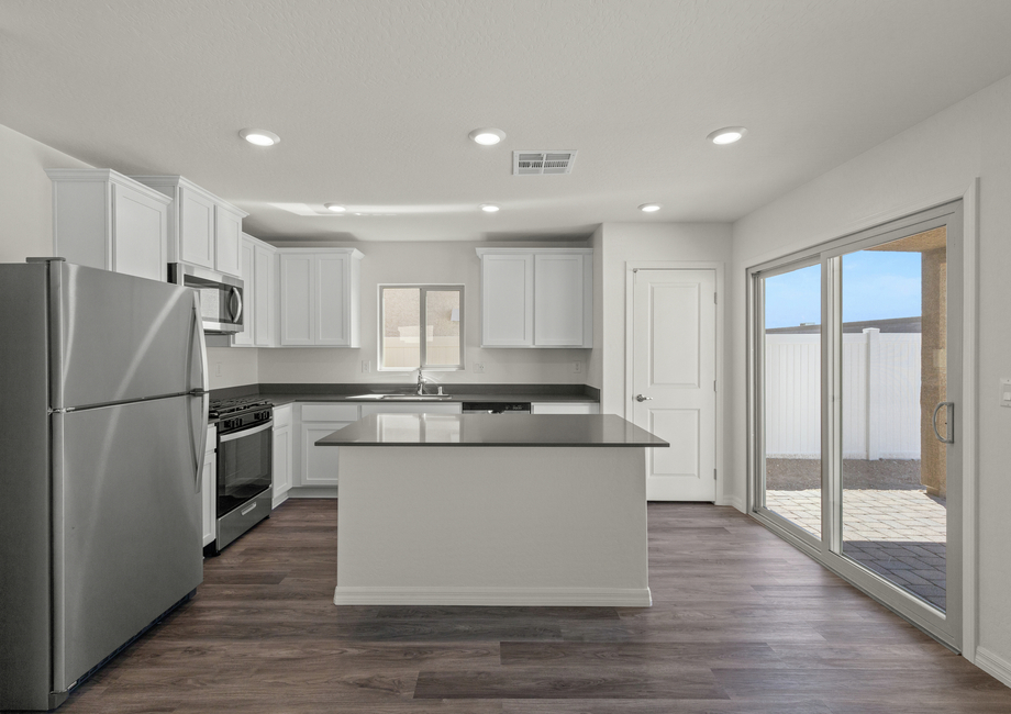 The kitchen of the Oak has a wonderful window and sliding glass door that let in great natural light.