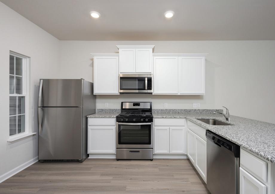 White cabinets and stainless stell appliances in the kitchen