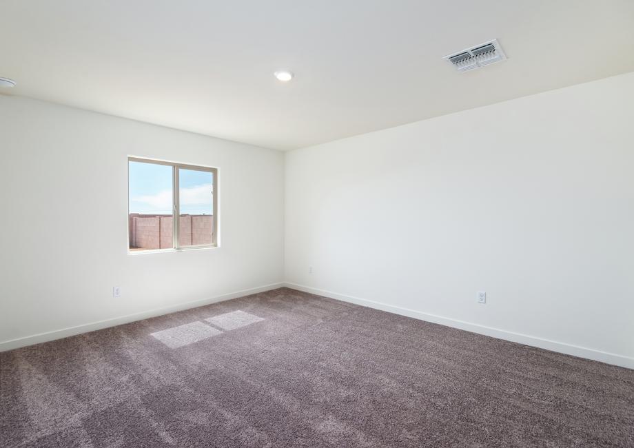 Windows let in natural light to this bedroom.