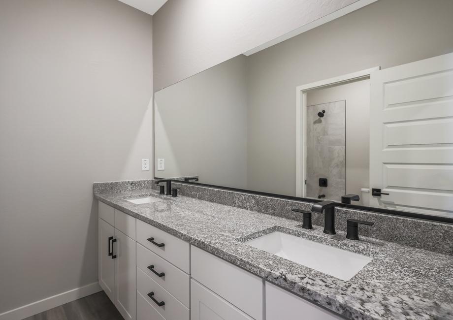 Guest bathroom with a double-sink vanity and private restroom.