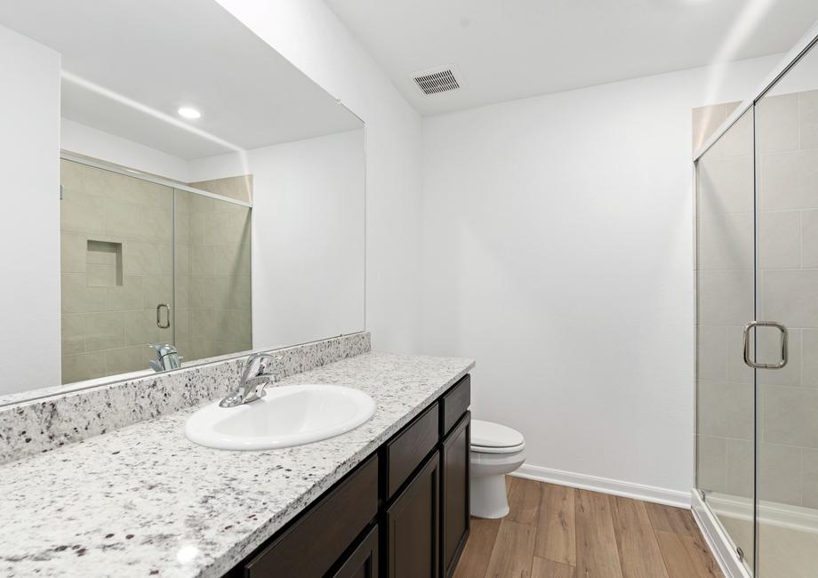 Master bathroom with a walk-in shower and expansive countertops.