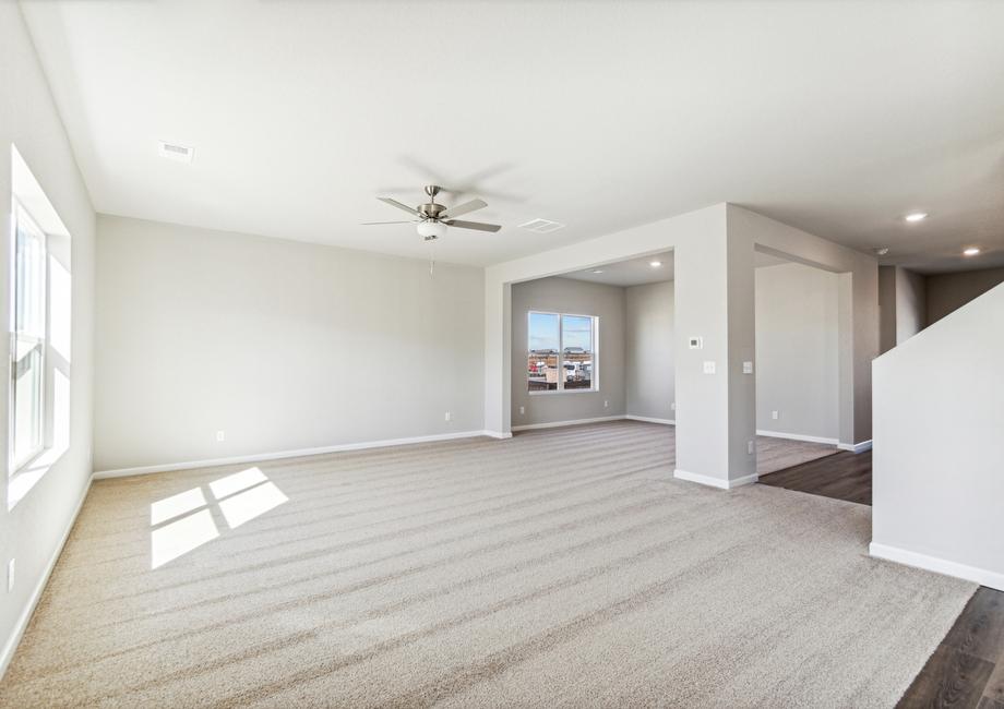The family room is spacious with a ceiling fan.