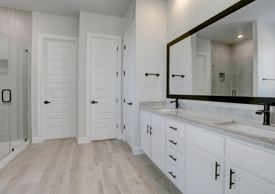 Master bathroom with two sinks and abundant counterspace and storage.