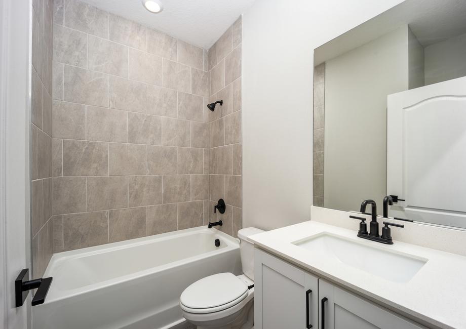 The secondary bathroom has modern fixtures and finishes