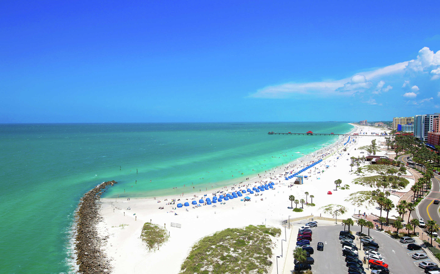 Tampa, Florida Clearwater Beach with white sands, green water, and blue sky