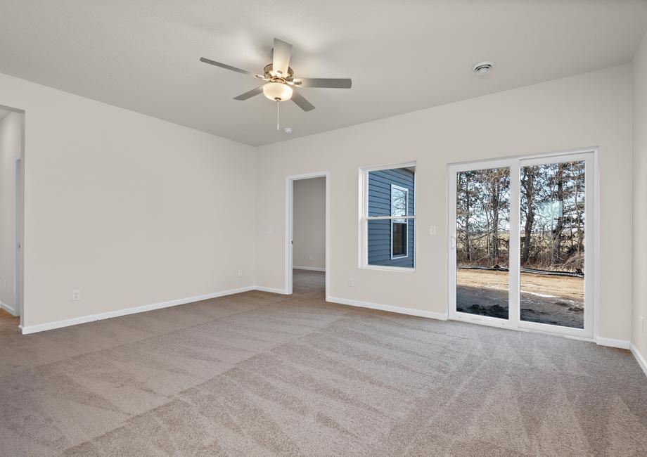 The family room is spacious with a ceiling fan.