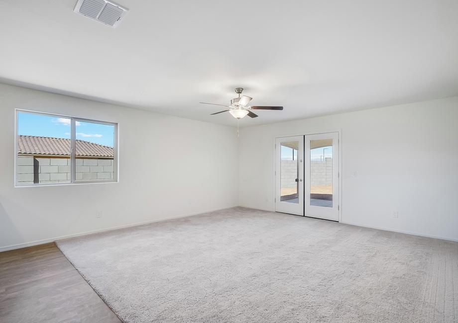 Expansive family room with double-doors leading to the covered back patio.