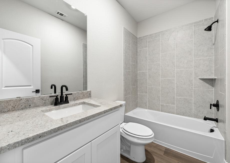 The secondary bathroom of the Rio Grande has a large vanity and shower-tub combo.