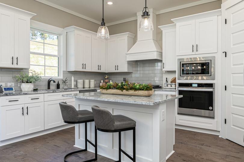 Angle shot of kitchen with granite island.