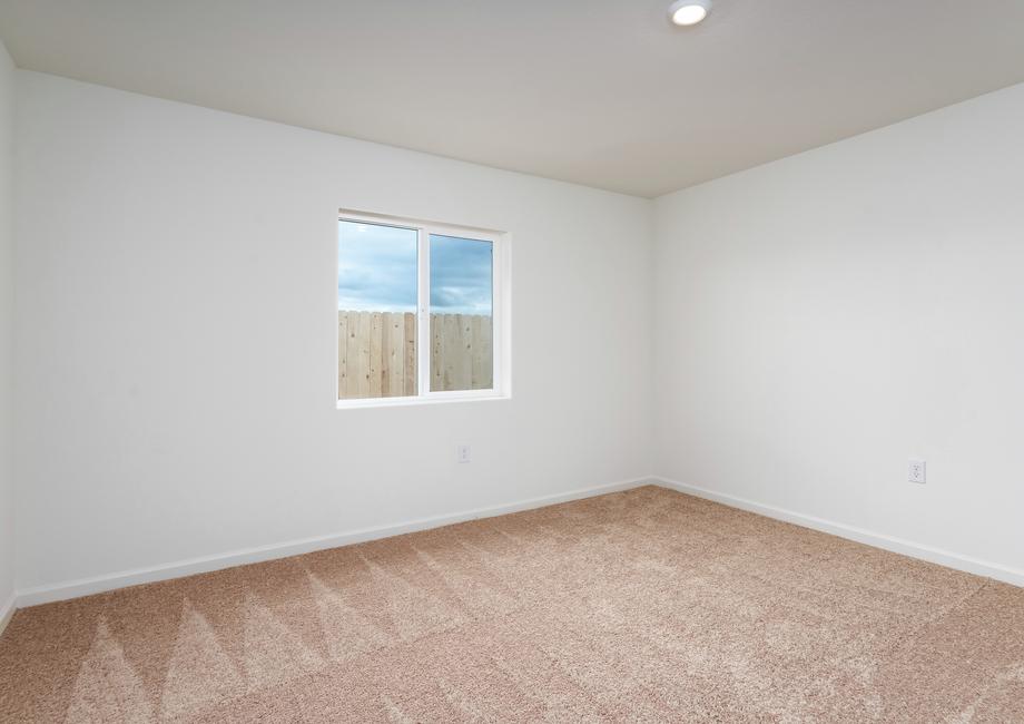 The master bedroom is spacious and has a large window.
