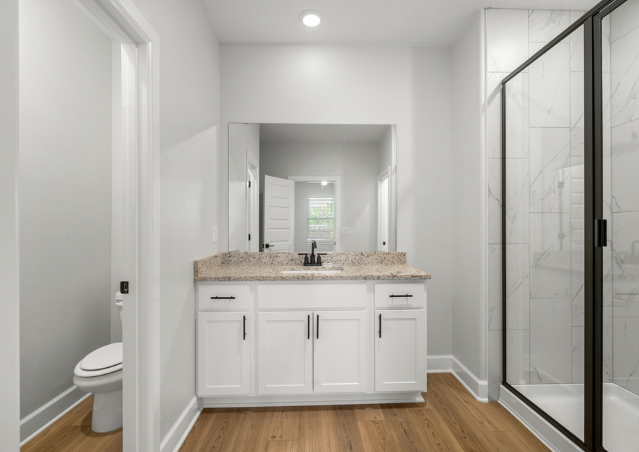 The master bathroom has a spacious vanity with plenty of counterspace.