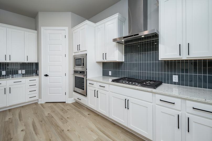 The white cabinets feature matte black hardware.
