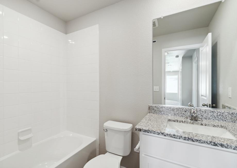 The secondary bathroom has a shower-tub combo.