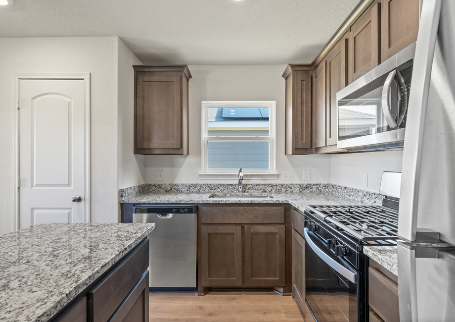 The kitchen has stainless steel appliances.