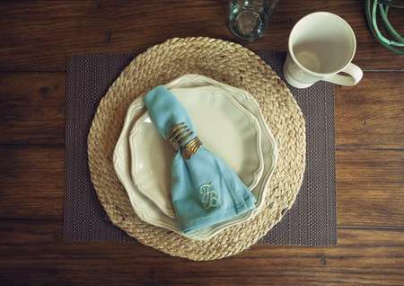 Dining room table with place setting.