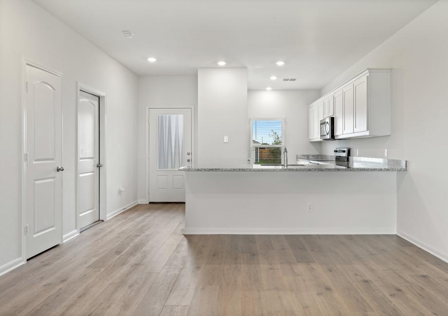 The kitchen and dining room of the Driftwood has beautiful wood-style, vinyl flooring.