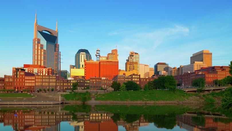 Nashville, Tennessee city buildings showing the still Cumberland River, industrial buildings, and tall skyscrapers