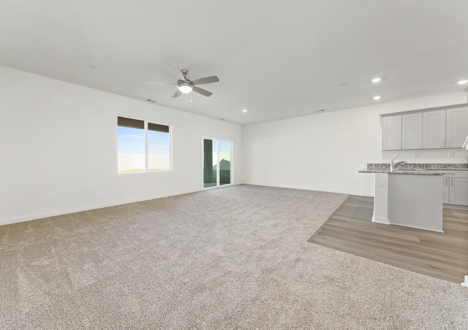 The family room is connected to the kitchen and has a ceiling fan.